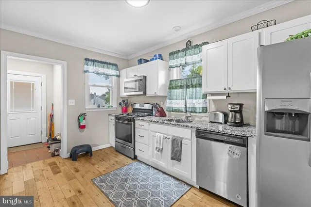 a kitchen with a stove oven and white cabinets