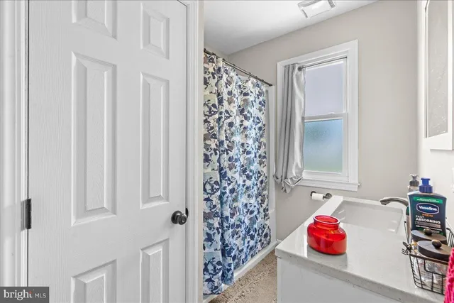 a bathroom with a shower curtain and a curtain