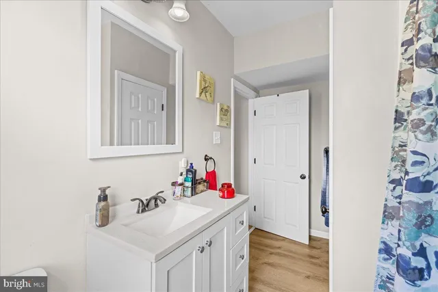 a bathroom with a sink vanity and a mirror