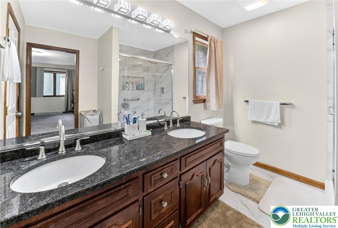 3746 Apple Road Orefield, PA 18069 - Photo 19 of 40 a bathroom with a granite countertop double vanity sink and a mirror