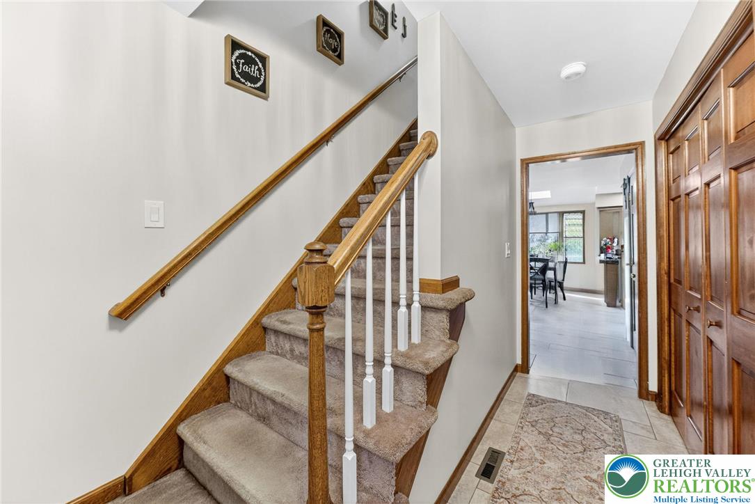 3746 Apple Road Orefield, PA 18069 - Photo 5 of 40 a view of staircase with lots of frames on wall and windows