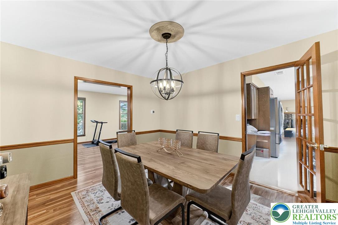 3746 Apple Road Orefield, PA 18069 - Photo 7 of 40 a view of a dining room with furniture wooden floor and a chandelier