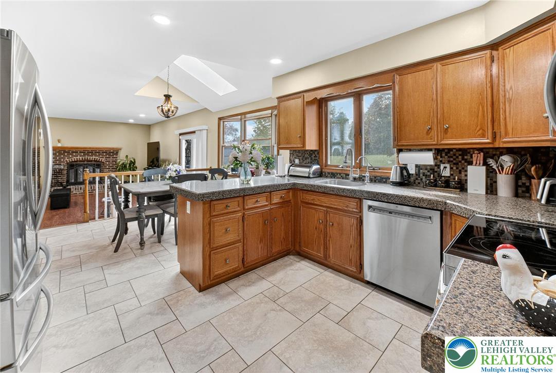 3746 Apple Road Orefield, PA 18069 - Photo 8 of 40 a kitchen with a sink stove and cabinets