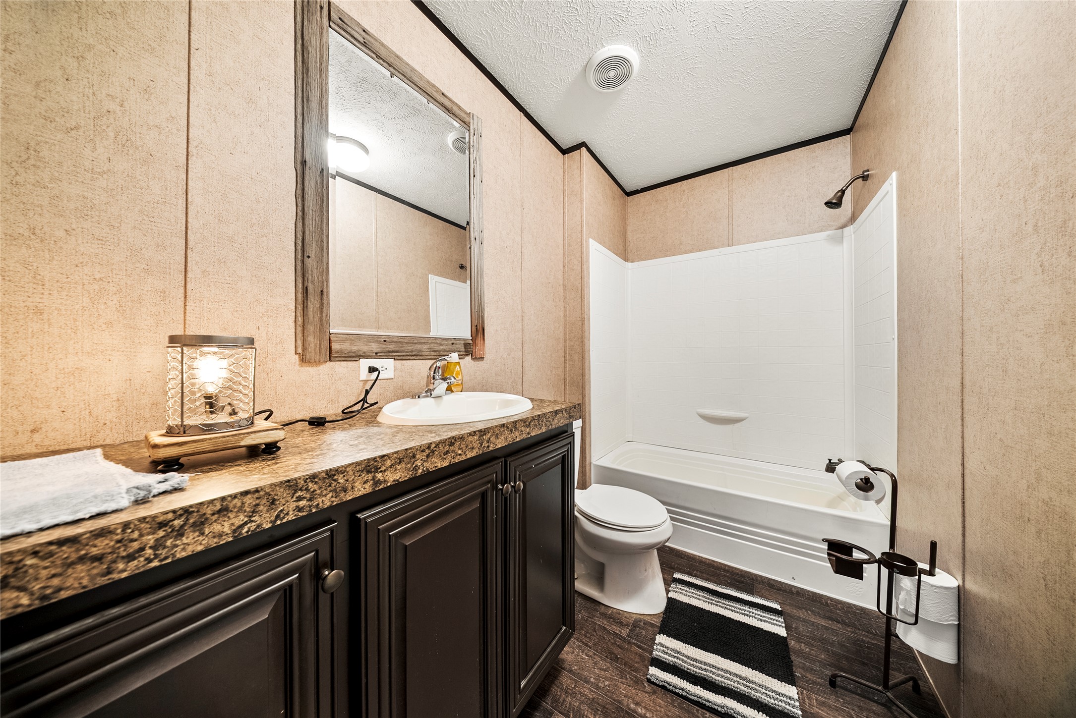 5101 County Road 463 Elgin, TX 78621 - Photo 25 of 38 Bathroom featuring a a vanity, shower combination, and dark wood-style flooring