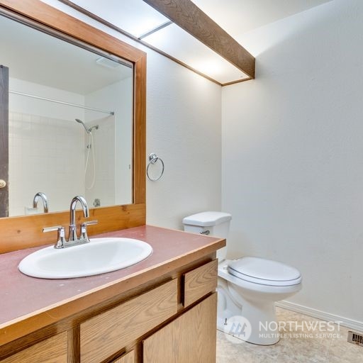 2813 Southwest 342nd Street Federal Way, WA 98023 - Photo 15 of 34 a bathroom with a sink a toilet and a mirror