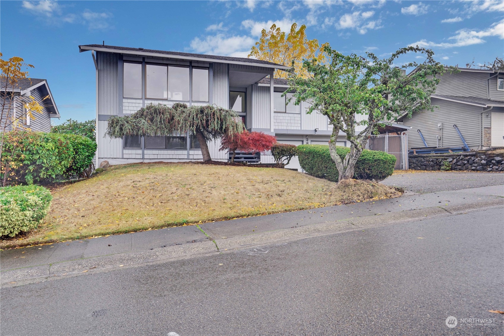 2813 Southwest 342nd Street Federal Way, WA 98023 - Photo 2 of 34 front view of a house with a yard and potted plants