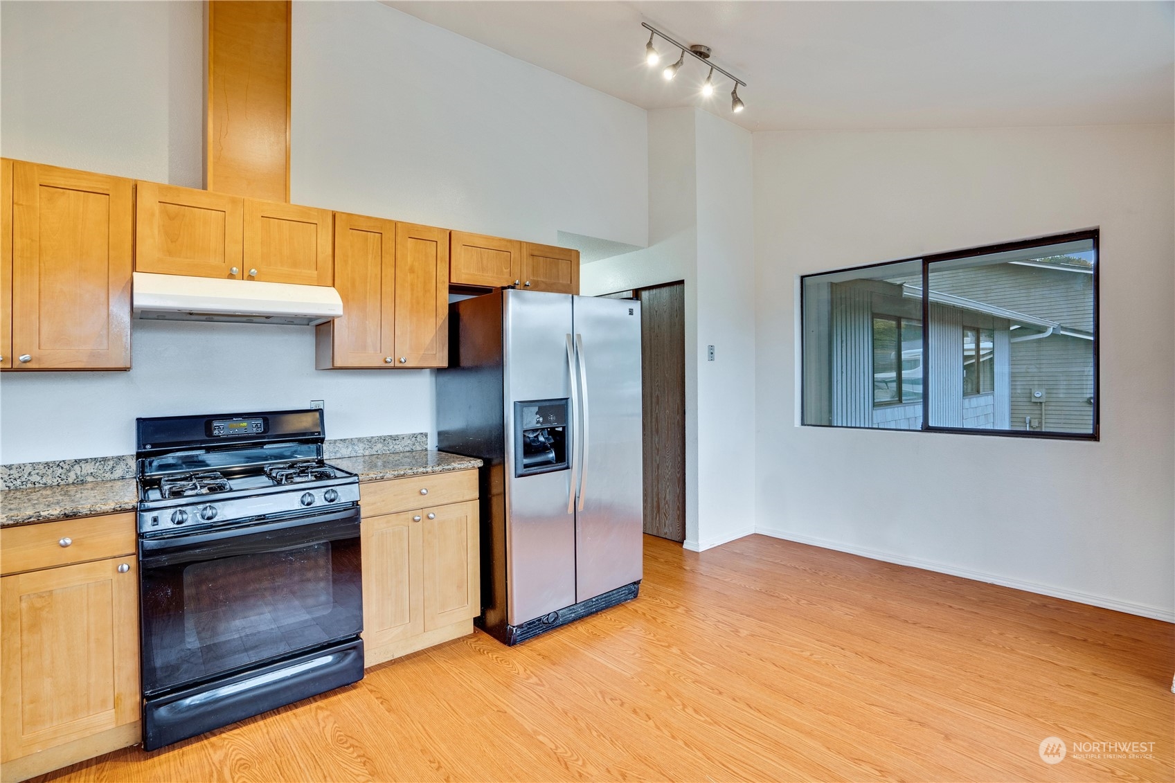 2813 Southwest 342nd Street Federal Way, WA 98023 - Photo 5 of 34 a kitchen with a stove a refrigerator and a stove top oven