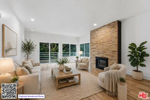 a living room with furniture fireplace and a large window