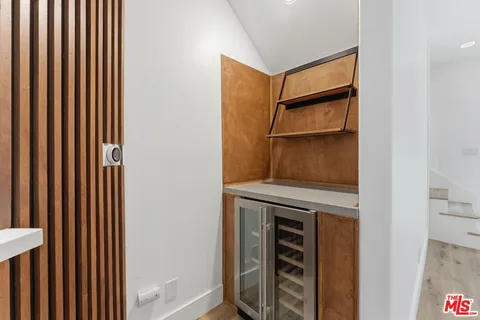 a view of an empty room with cabinet door
