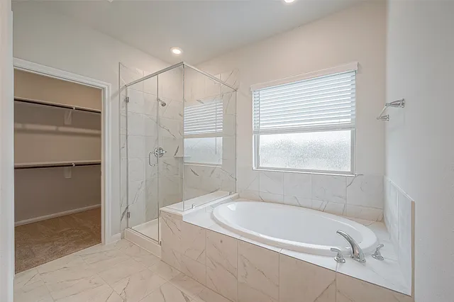 a bathroom with a bathtub and a shower