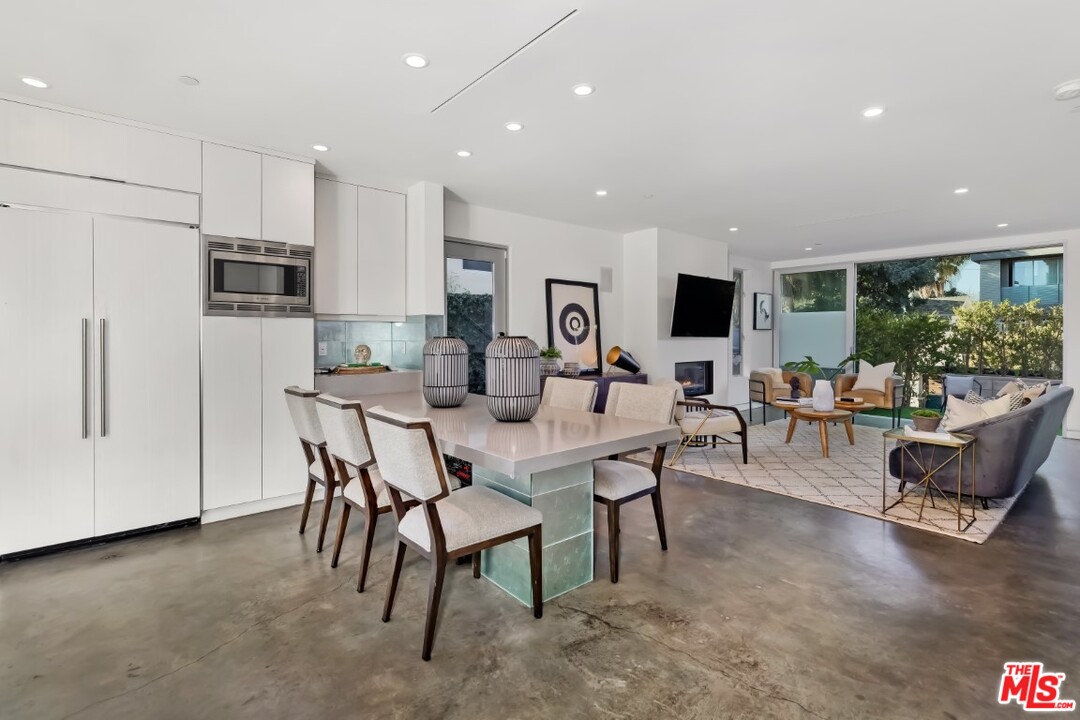 808 Brooks Avenue Venice, CA 90291 - Photo 14 of 47 a living room with furniture a flat screen tv and a refrigerator