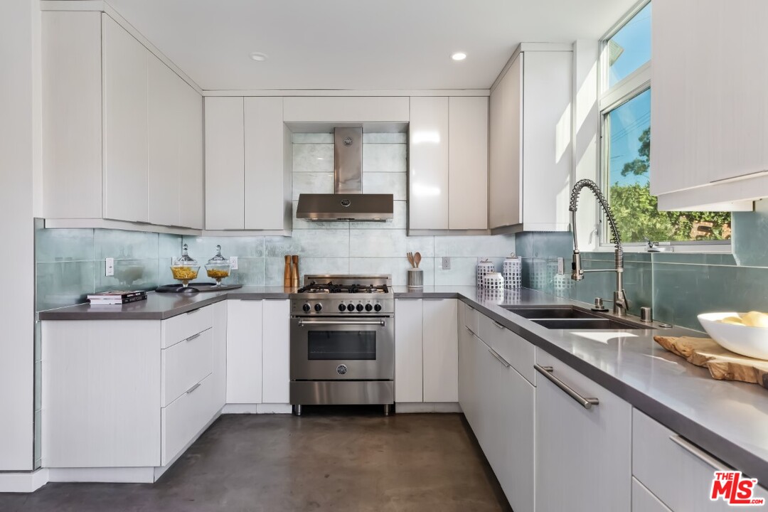 808 Brooks Avenue Venice, CA 90291 - Photo 15 of 47 a kitchen with stainless steel appliances granite countertop a sink stove and refrigerator