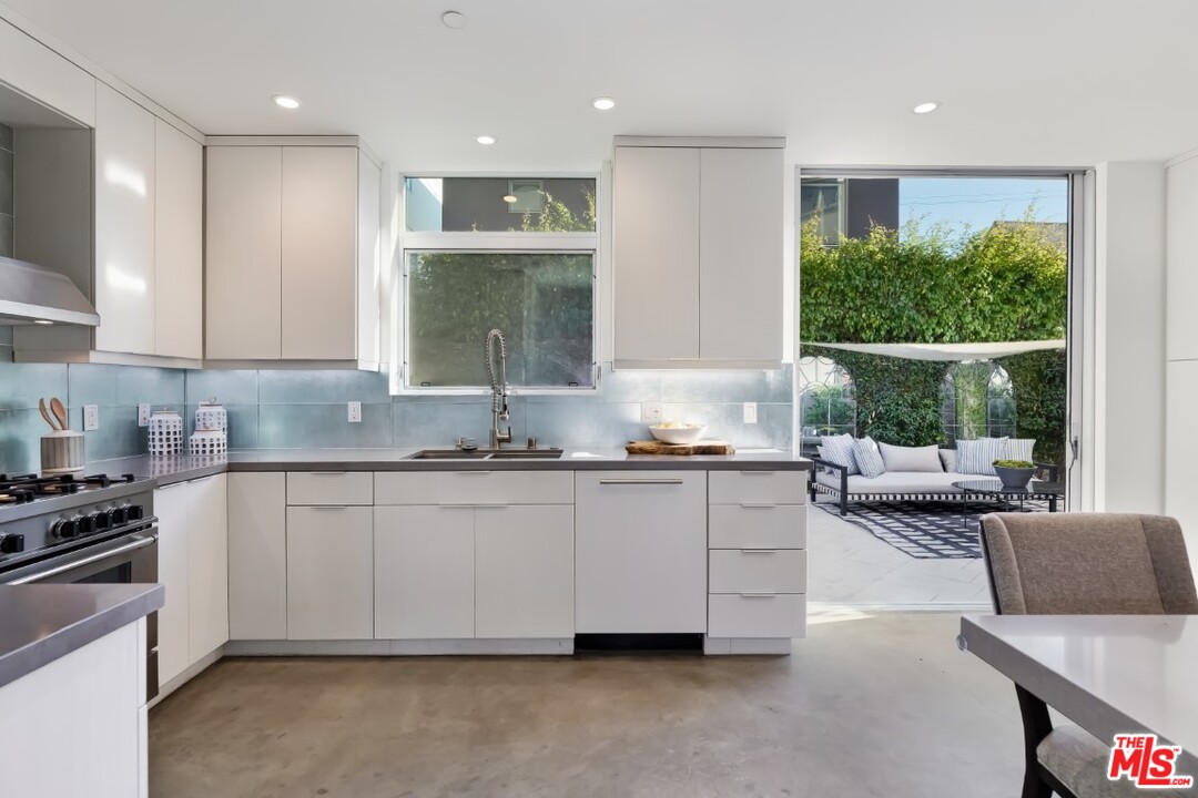 808 Brooks Avenue Venice, CA 90291 - Photo 16 of 47 a kitchen with granite countertop a sink and white cabinets