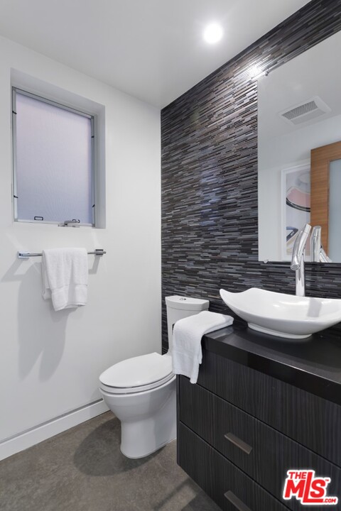808 Brooks Avenue Venice, CA 90291 - Photo 18 of 47 a bathroom with a granite countertop toilet sink and mirror