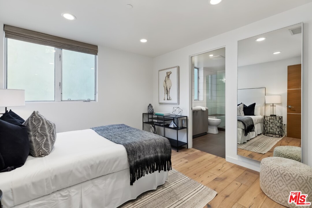 808 Brooks Avenue Venice, CA 90291 - Photo 40 of 47 a bedroom with a bed couch and wooden floor