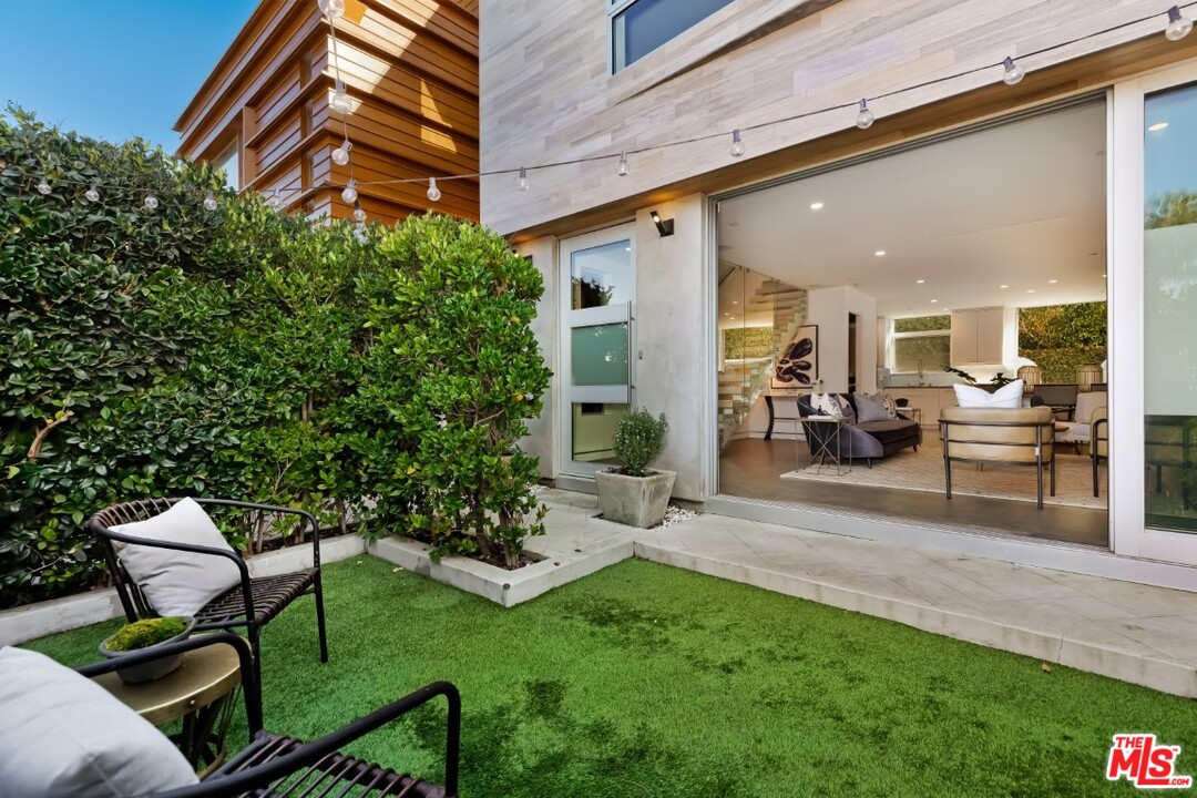 808 Brooks Avenue Venice, CA 90291 - Photo 5 of 47 a view of a patio with table and chairs potted plants and floor to ceiling window