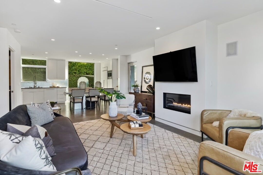 808 Brooks Avenue Venice, CA 90291 - Photo 7 of 47 a living room with furniture a flat screen tv and a fireplace
