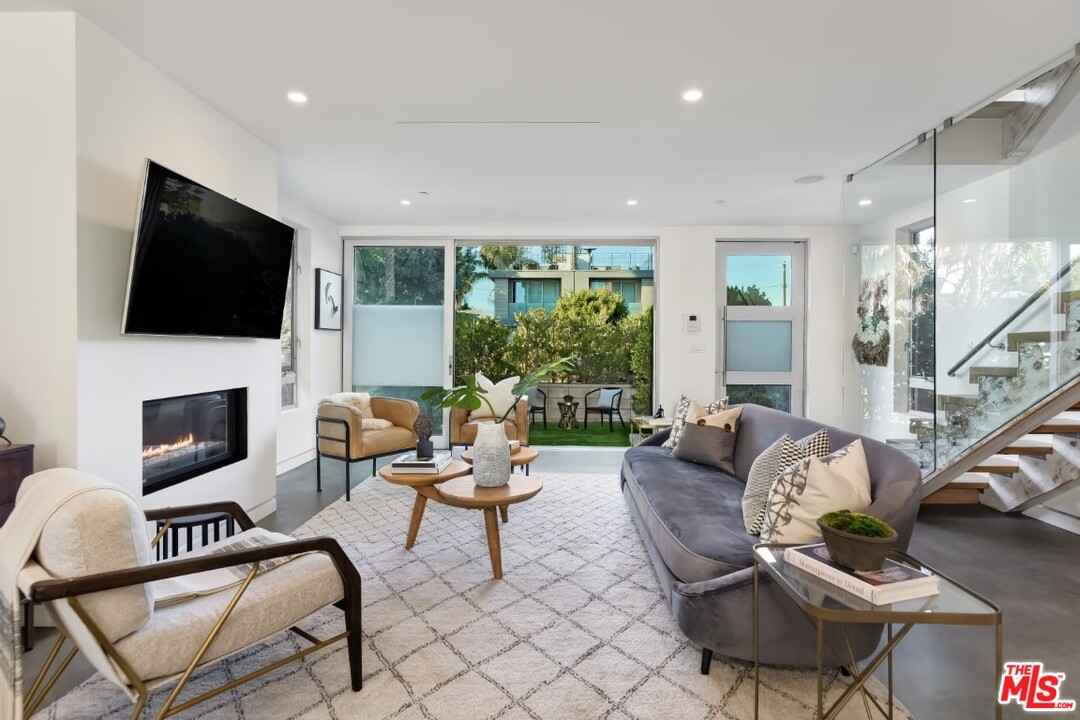 808 Brooks Avenue Venice, CA 90291 - Photo 10 of 47 a living room with fireplace furniture and a flat screen tv
