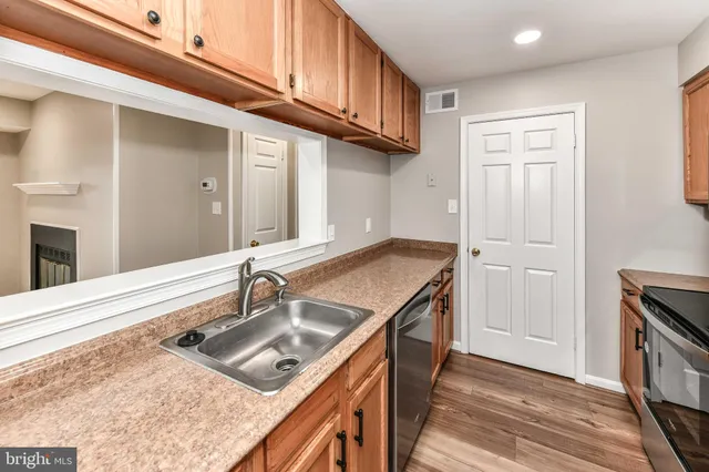 a kitchen with a sink stove and cabinets