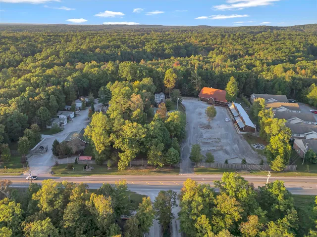 an aerial view of a house with a yard and street view