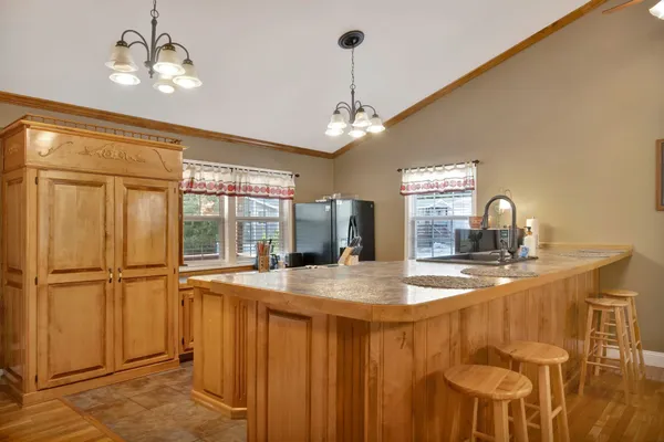 a bedroom with a bed ceiling fan and a wooden floor