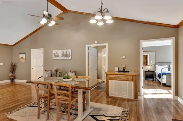a living room with furniture a flat screen tv and kitchen view