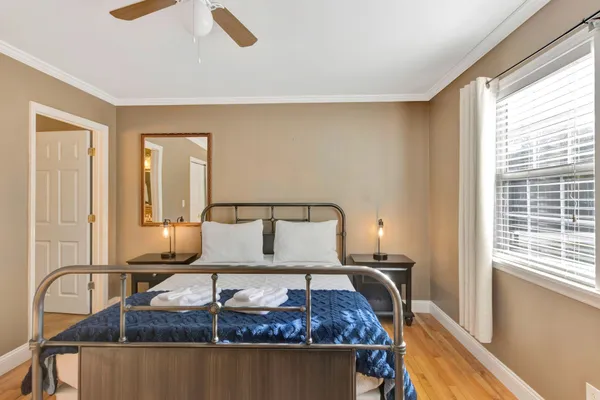 a bedroom with a bed and a chandelier