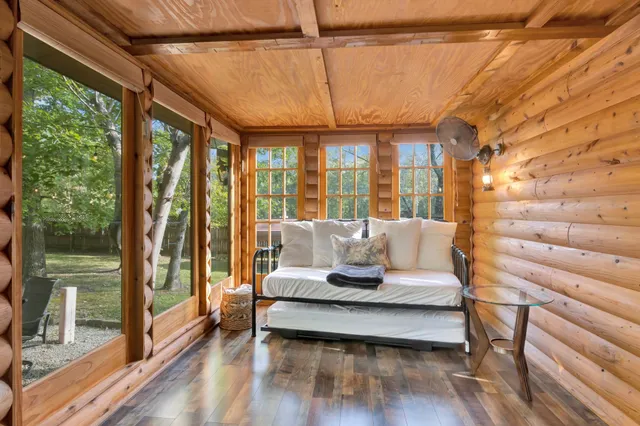 a dining room with a wooden table and chairs