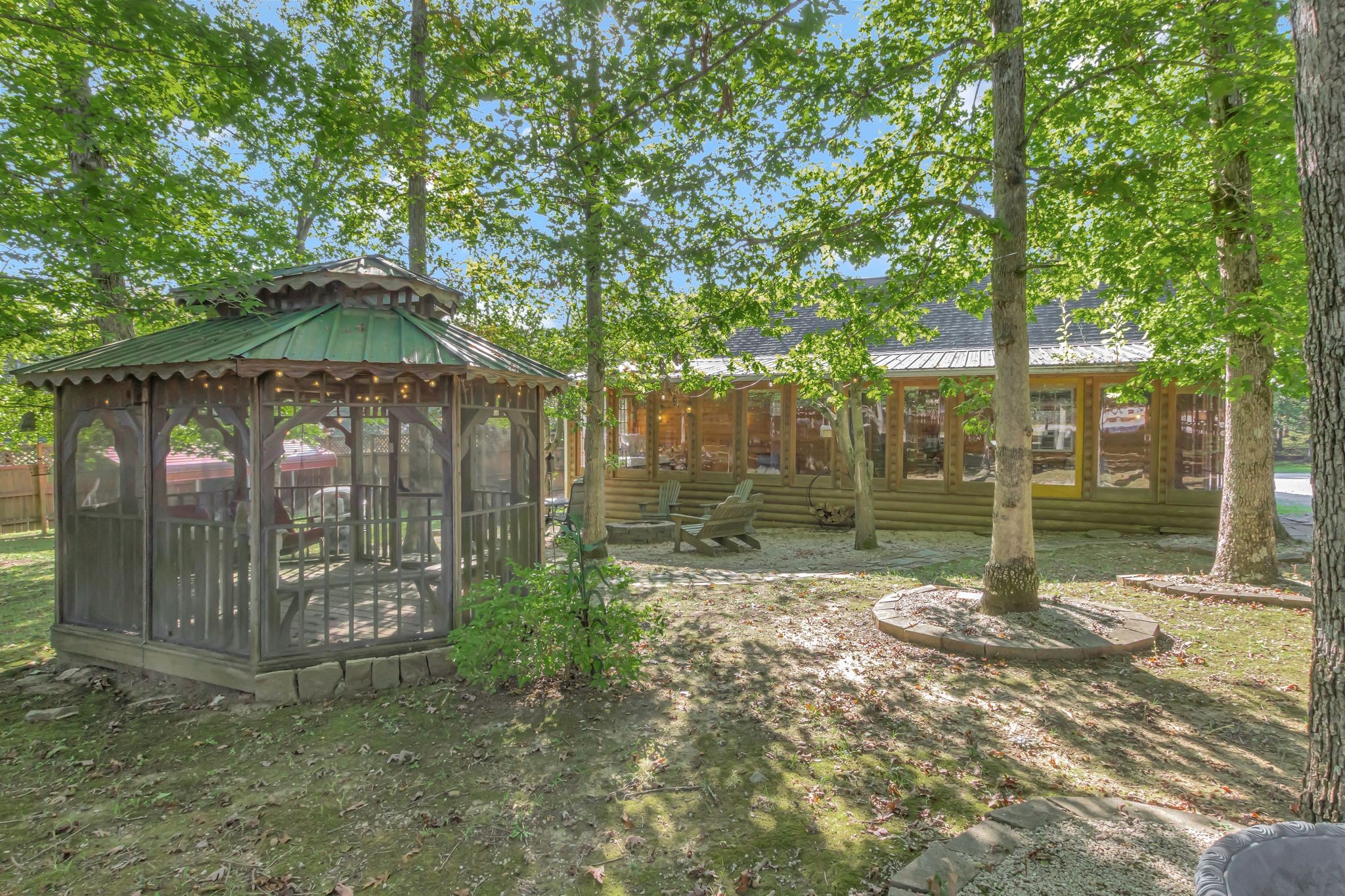 11845 Highway 41 Monteagle, TN 37356 - Photo 31 of 74 a view of a back yard with a table and chairs under an umbrella