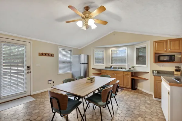 a view of a house with wooden fence next to a house