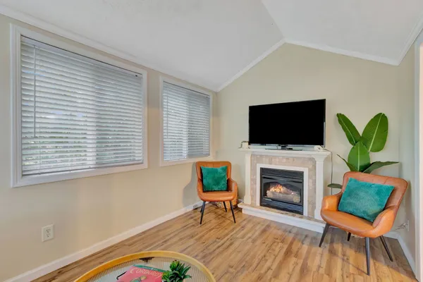 a view of a hallway with furniture and wooden floor