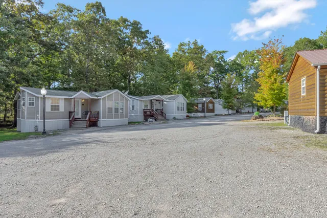 a spacious bathroom with a double vanity sink a mirror a toilet and shower