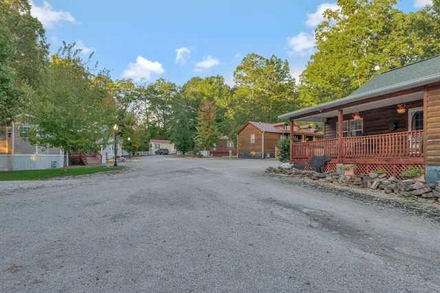 a view of a dining room with furniture a chandelier and wooden floor