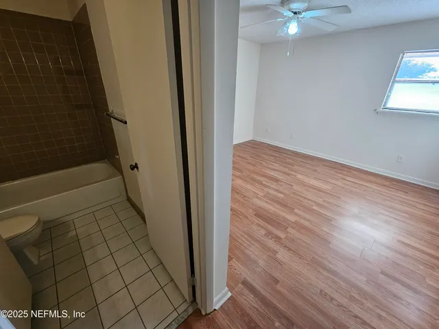 a view of an empty room and wooden floor
