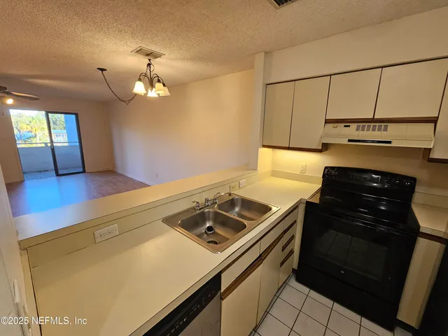 a kitchen with a stove and a microwave