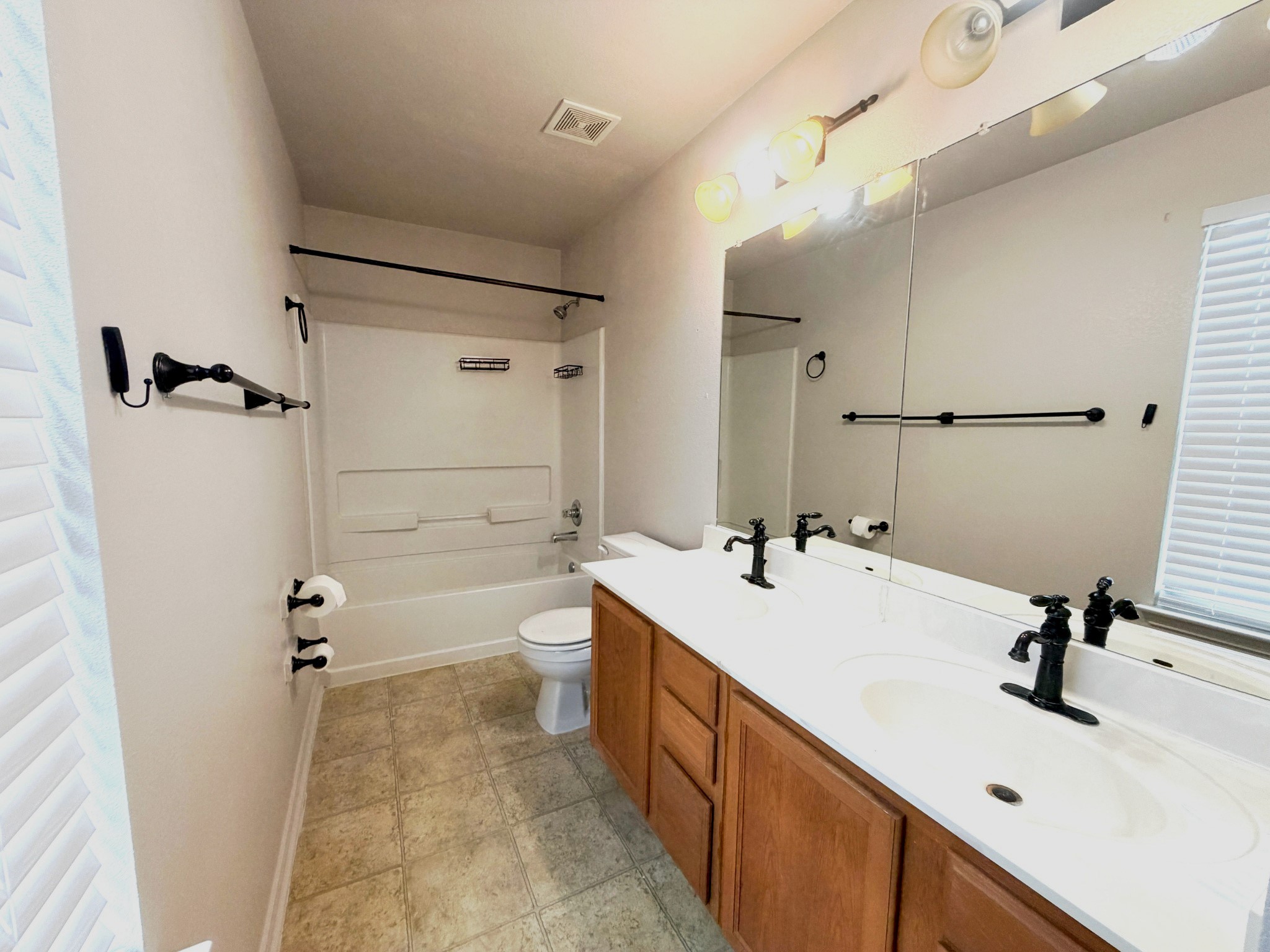 4601 Nuckols Crossing Road Austin, TX 78744 - Photo 9 of 18 Clean lines and a spacious dual vanity define the primary bathroom.