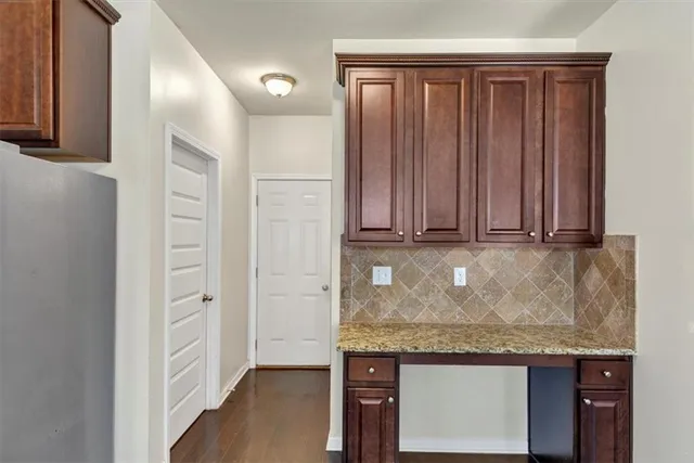 a kitchen with granite countertop a stove and cabinets