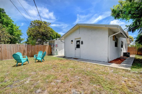 a backyard of a house with table and chairs