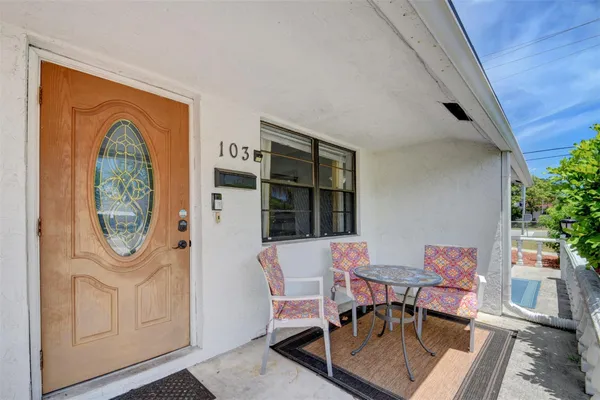 a dining room with furniture a rug and a window