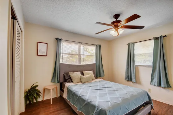 a bedroom with a bed and a large mirror