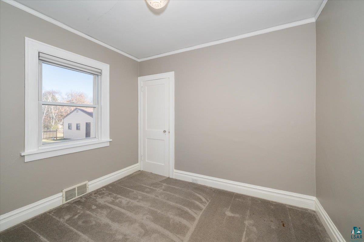1906 Springvale Road Duluth, MN 55811 - Photo 11 of 15 Carpeted empty room with ornamental molding