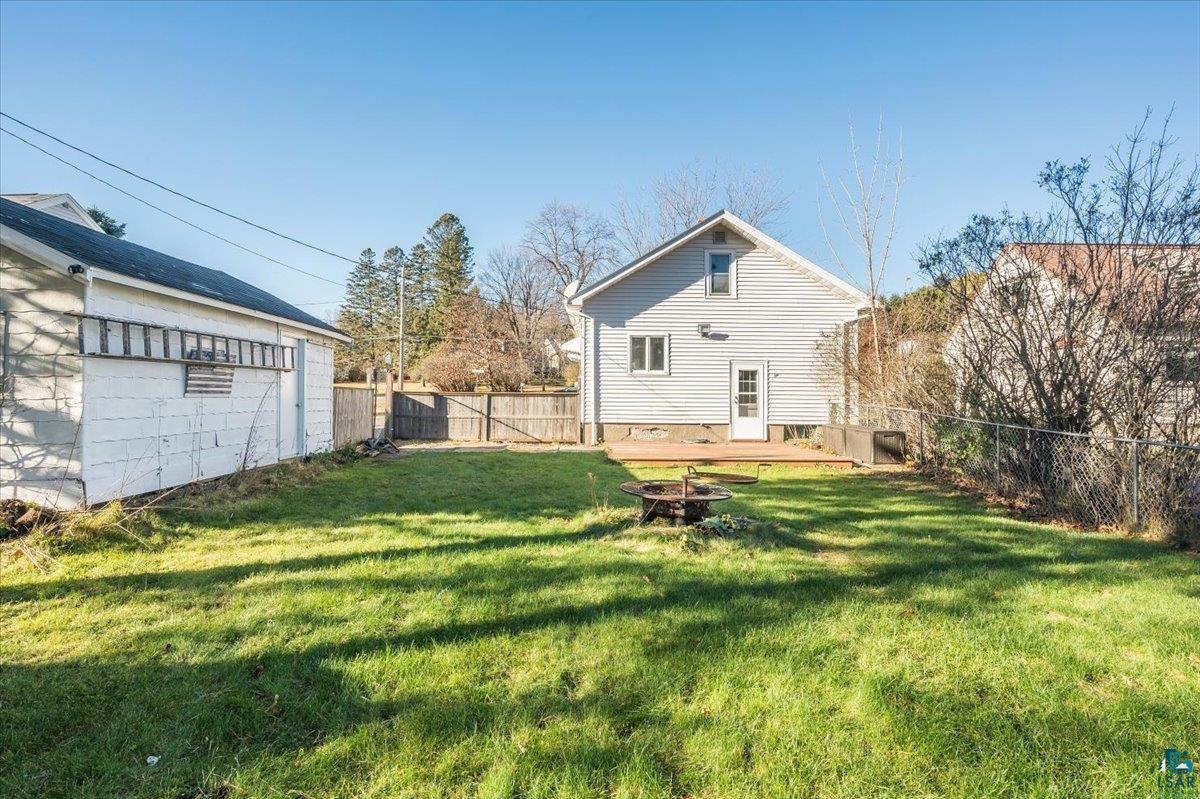 1906 Springvale Road Duluth, MN 55811 - Photo 3 of 15 View of yard featuring a fire pit and a wooden deck