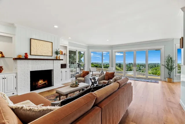 a living room with fireplace furniture and a wooden floor