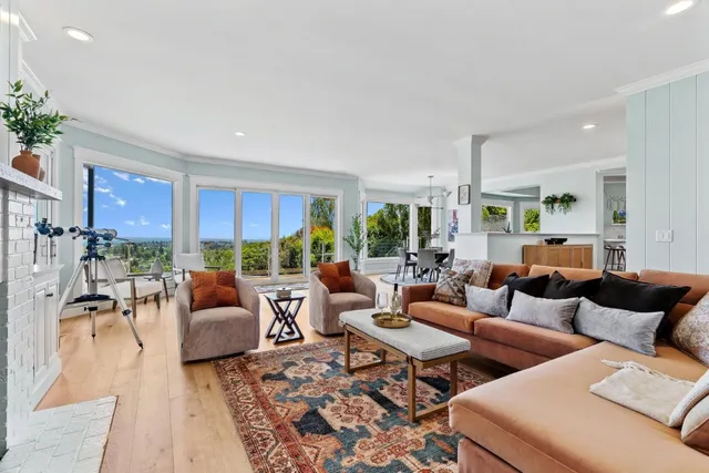 a dining room with furniture window and wooden floor