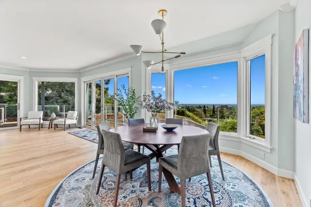 a living room with furniture and a dining table with kitchen view