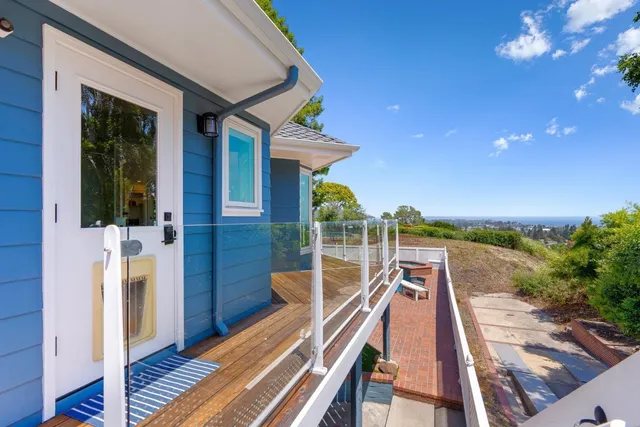 a bedroom with a bed a large window with table and chair