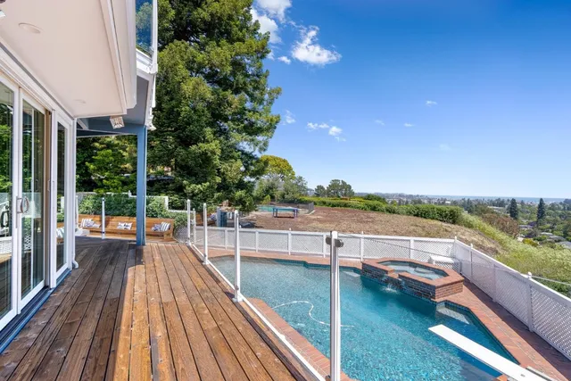 a spacious bedroom with a bed a window and a chandelier