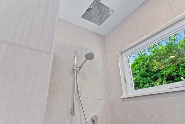 a bathroom with a granite countertop sink and a large mirror
