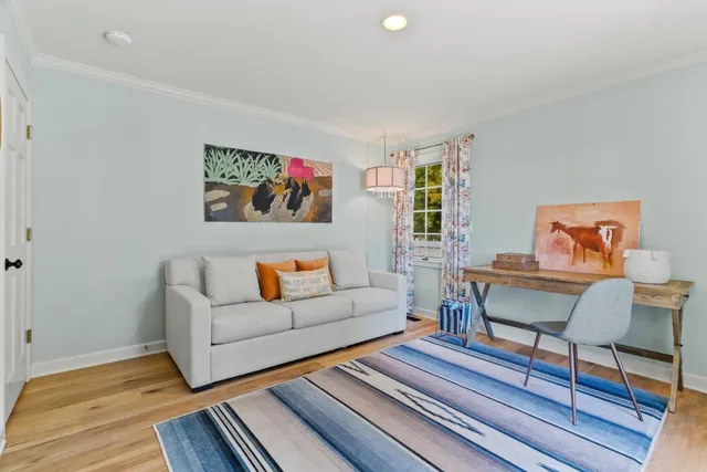a kitchen with stainless steel appliances a sink and a stove with wooden floor