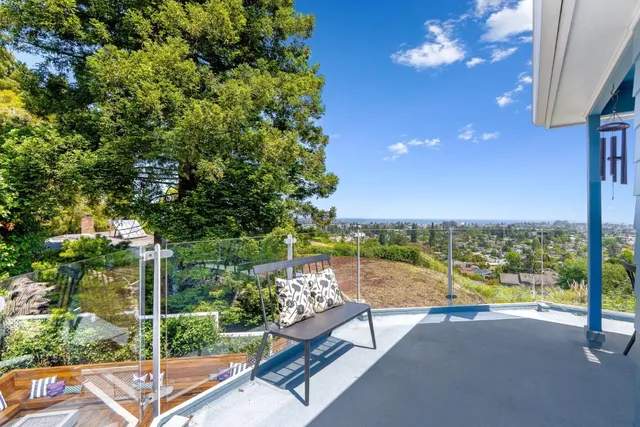 a view of a balcony with lake view and a floor to ceiling window with wooden floor